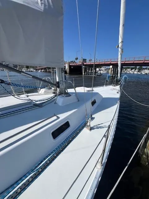 Slide: The Image of Sailboat J/42 from 1998 docked at marina, clear blue sky background. - 15