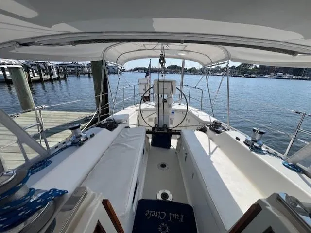 Slide: The Image of 1998 J Boats J/42 sailboat cockpit with canopy, docked at marina, calm water view. - 18