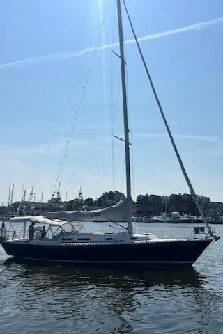 Slide: The Image of 1998 J Boats J/42 sailboat on calm water, clear sky background. - 2