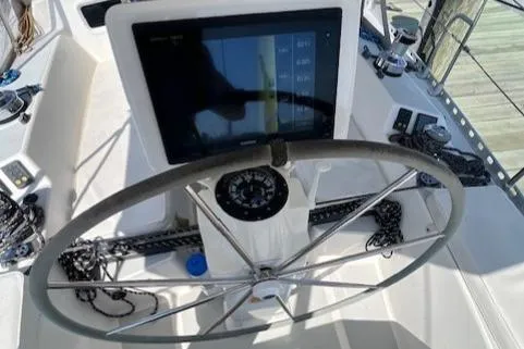 Slide: The Image of 1998 J Boats J/42 yacht cockpit with steering wheel and navigation display. - 20