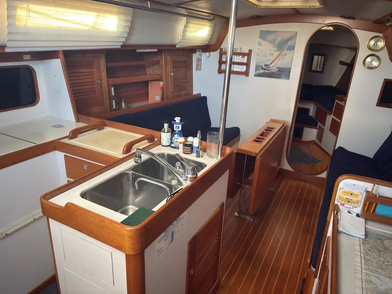 Slide: The Image of Interior of 1998 J Boats J/42 sailboat with kitchen and seating area. - 24