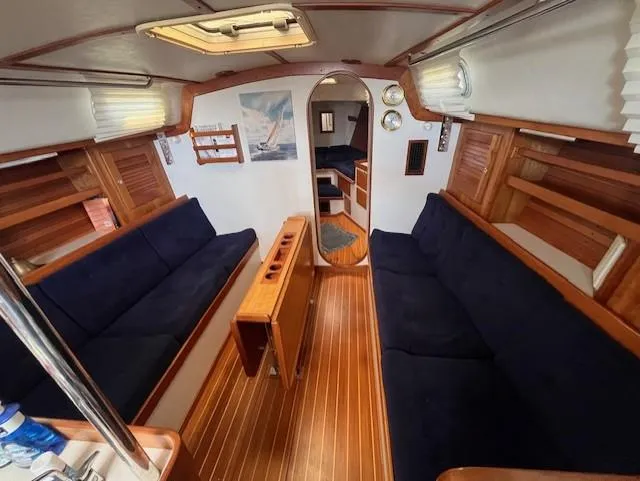 Slide: The Image of Interior of 1998 J Boats J/42 sailboat with wooden finish and navy seating. - 27