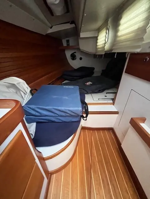 Slide: The Image of 1998 J Boats J/42 cabin interior with wooden flooring and cushioned seating. - 28