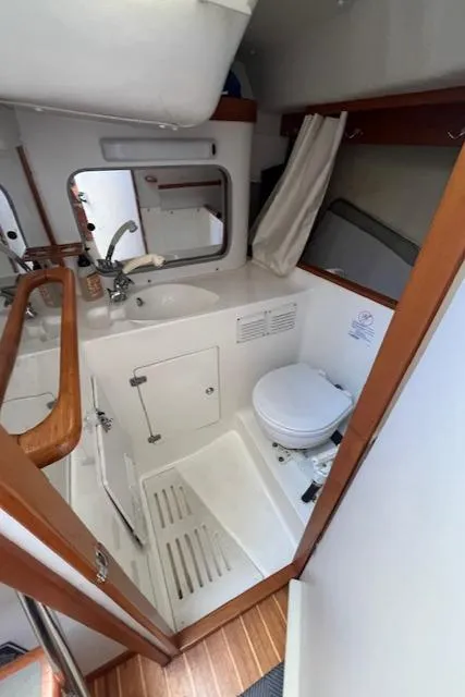 Slide: The Image of 1998 J Boats J/42 yacht bathroom with sink, toilet, and shower area. - 29