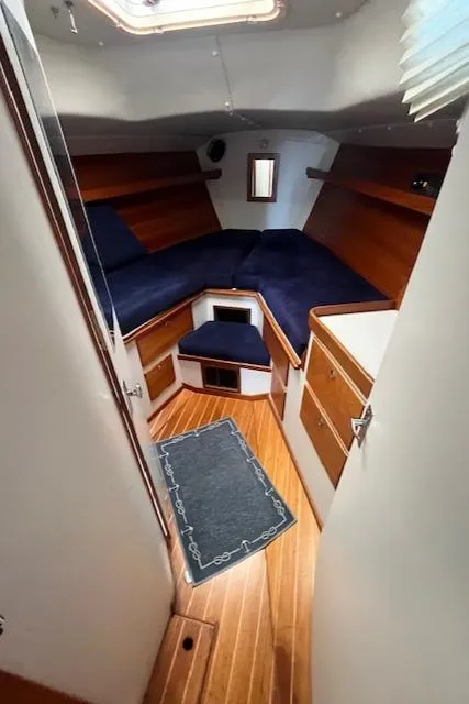 Slide: The Image of 1998 J Boats J/42 cabin interior with wooden finish and blue upholstery. - 30