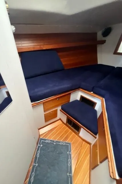 Slide: The Image of Interior cabin of 1998 J Boats J/42 with blue cushions and wooden accents. - 32