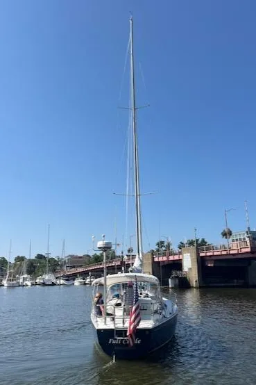 Slide: The Image of Sailboat J/42 from 1998 by J Boats docked in a marina under clear blue sky. - 6