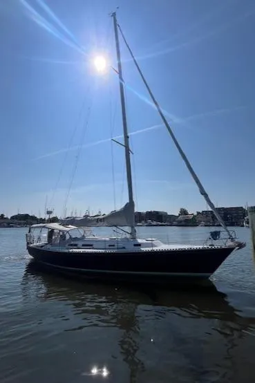 Slide: The Image of 1998 J Boats J/42 sailboat on calm water under bright sun. - 7