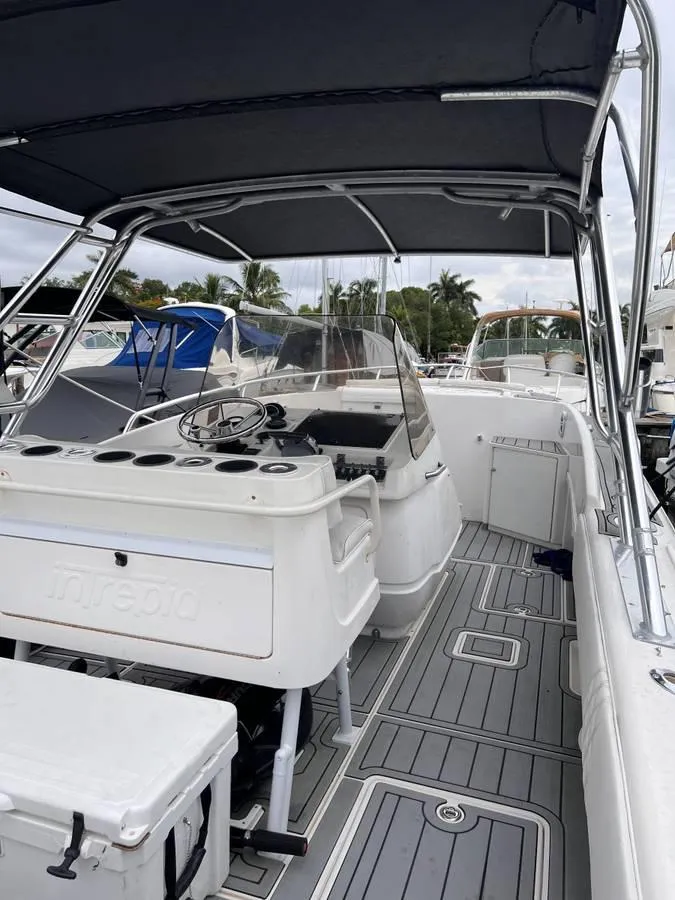 Slide: The Image of 1996 Intrepid 370 Cuddy boat interior with helm, seating, and canopy. - 10