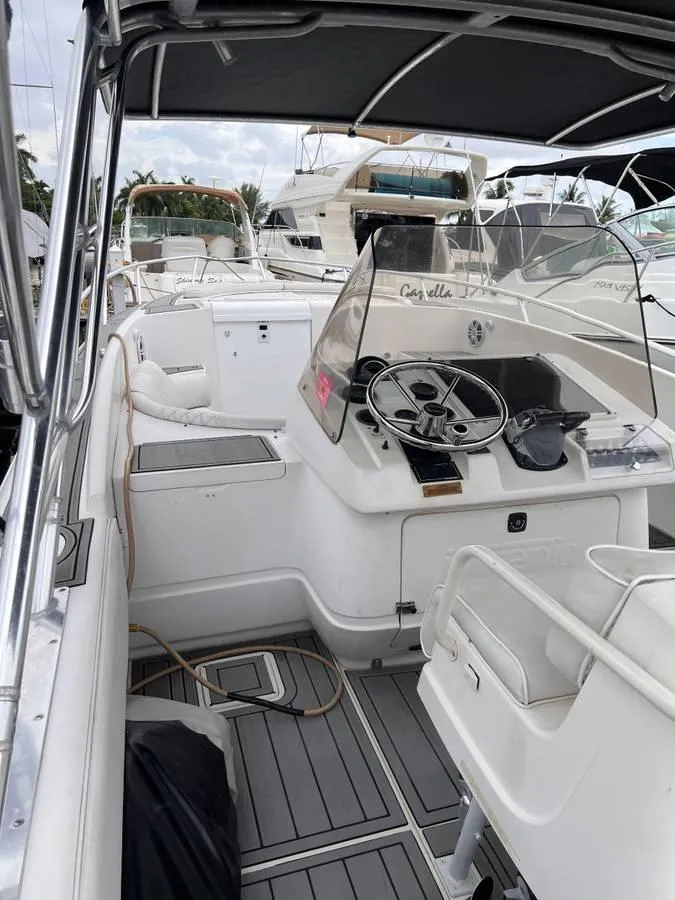 Slide: The Image of 1996 Intrepid 370 Cuddy boat interior with steering wheel and seating area. - 12