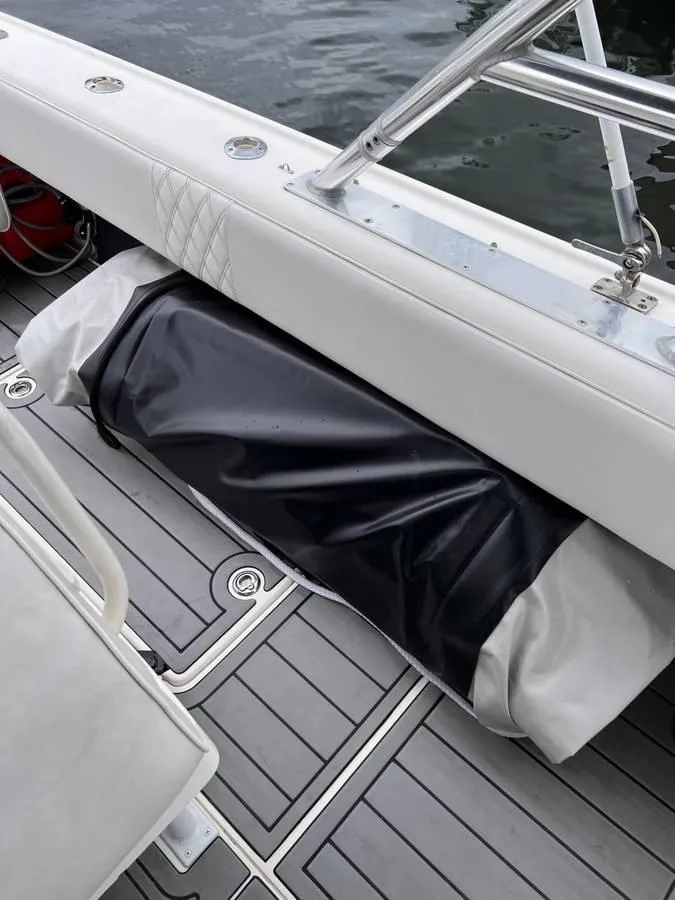 Slide: The Image of 1996 Intrepid 370 Cuddy boat interior with cushioned seating and storage compartment. - 16