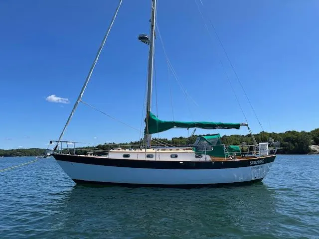 Slide: The Image of 1979 Morris Leigh 30 sailboat on calm water under clear blue sky. - 0