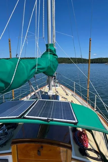 Slide: The Image of Sailboat deck with solar panels, Morris Leigh 30, 1979 model, on calm water. - 12