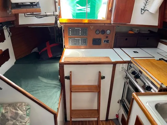 Slide: The Image of Interior of a 1979 Morris Leigh 30 sailboat with cozy cabin and kitchen area. - 2