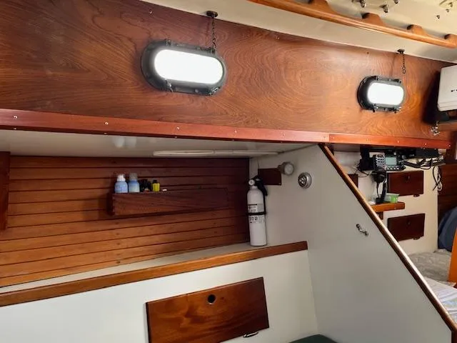Slide: The Image of Interior of a 1979 Morris Leigh 30 sailboat with wooden paneling and porthole windows. - 5