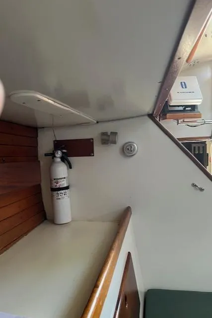Slide: The Image of Interior of a 1979 Morris Leigh 30 sailboat with fire extinguisher and wooden accents. - 8