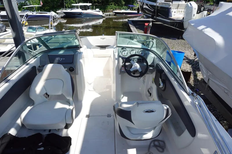 Slide: The Image of 2013 Chaparral 19 Sport H2O boat interior with steering wheel and seating. - 10
