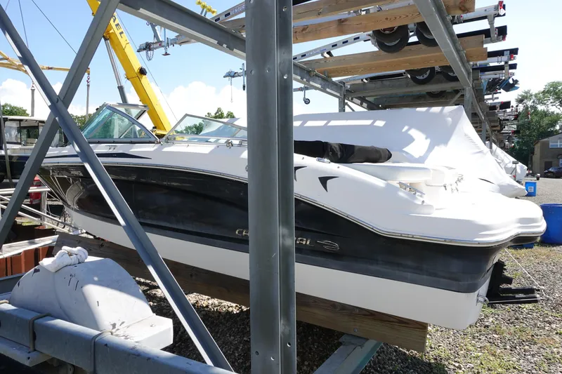 Slide: The Image of 2013 Chaparral 19 Sport H2O boat stored on a rack outdoors. - 3