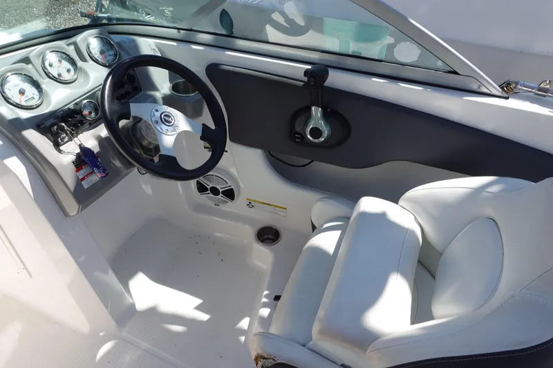 Slide: The Image of 2013 Chaparral 19 Sport H2O boat cockpit with steering wheel and gauges. - 5