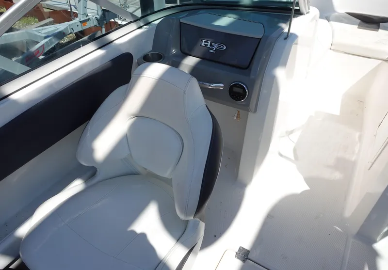 Slide: The Image of 2013 Chaparral 19 Sport H2O boat interior with white seating and dashboard. - 9