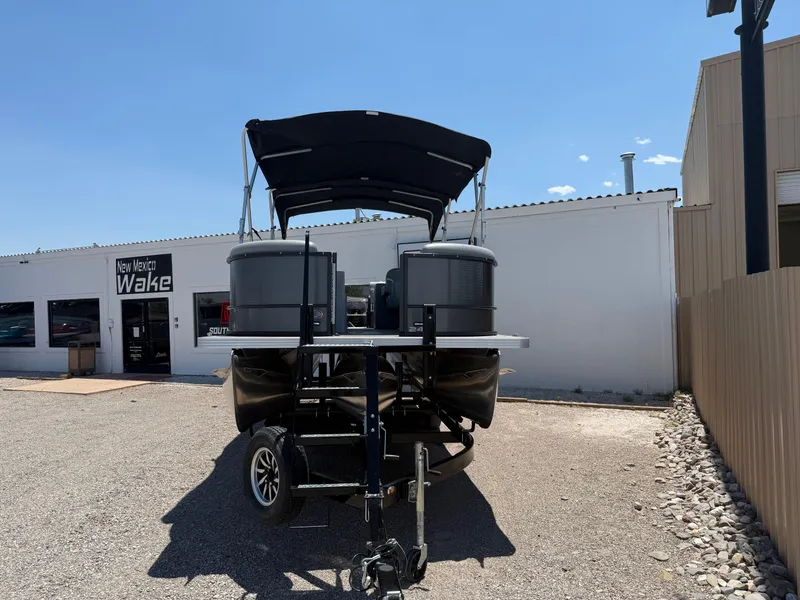 Slide: The Image of 2024 Crest Classic DLX 240 SLRC pontoon boat on trailer at New Mexico Wake dealership. - 3