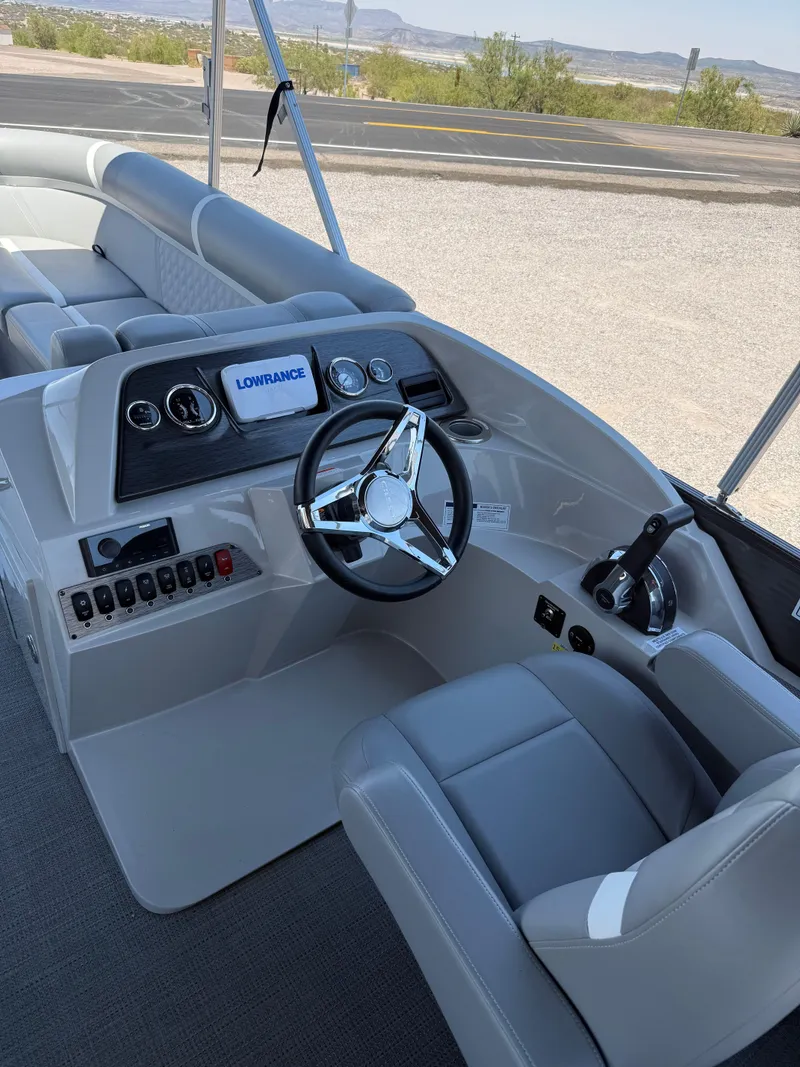 Slide: The Image of 2024 Crest Classic DLX 240 SLRC boat interior with steering wheel and control panel. - 7
