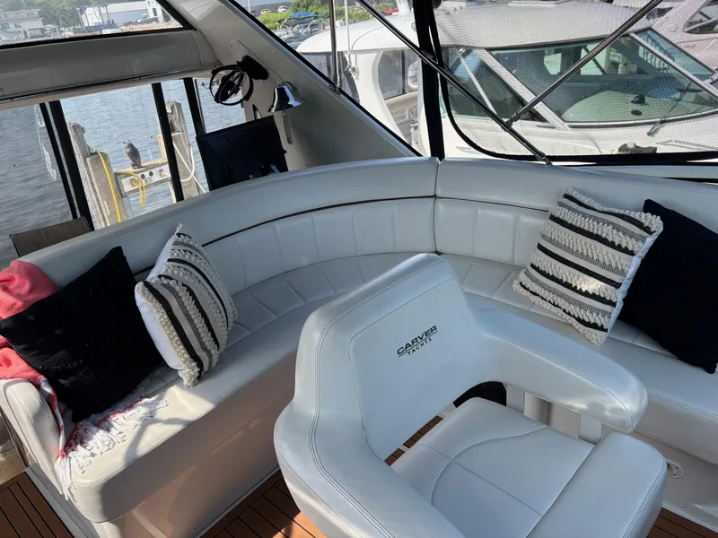 Slide: The Image of Luxurious 2003 Carver 444 Cockpit Motor Yacht interior with plush seating and decorative pillows. - 26
