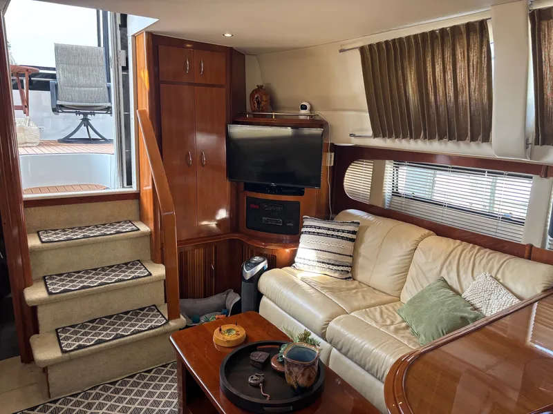 Slide: The Image of Luxurious interior of 2003 Carver 444 Cockpit Motor Yacht with cozy seating and entertainment area. - 35
