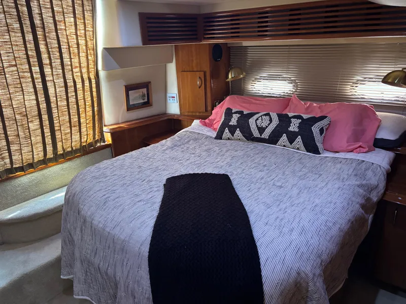 Slide: The Image of Luxurious bedroom in 2003 Carver 444 Cockpit Motor Yacht with cozy bedding and elegant decor. - 36