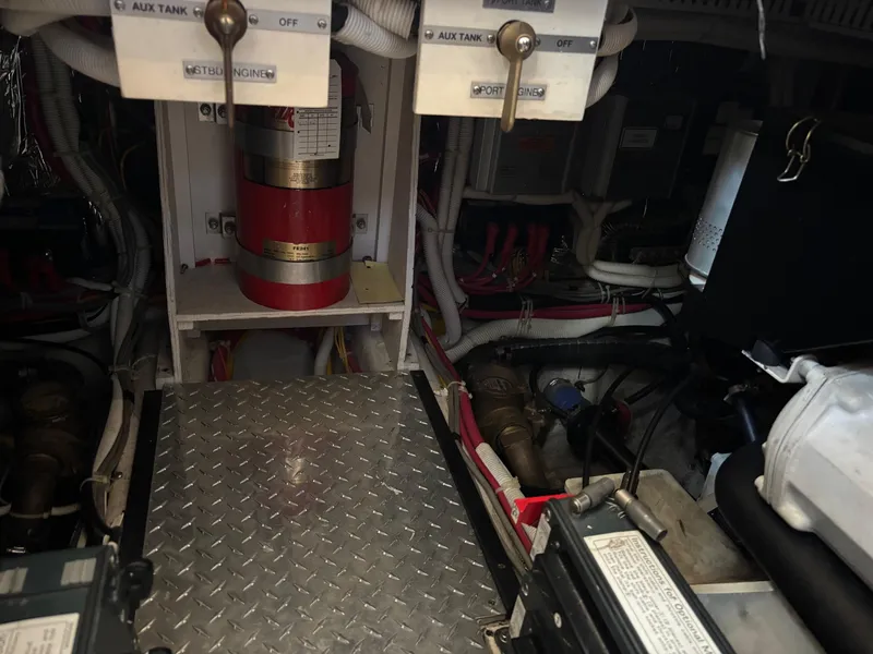 Slide: The Image of Engine room of 2003 Carver 444 Cockpit Motor Yacht with fire extinguisher and wiring. - 45