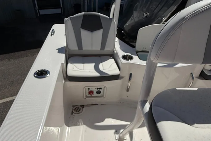 Slide: The Image of 2025 Robalo 206 Cayman boat interior with cushioned seating and cup holders. - 12