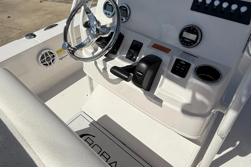 Slide: The Image of 2025 Robalo 206 Cayman boat dashboard with steering wheel and controls. - 13