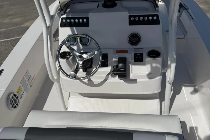 Slide: The Image of 2025 Robalo 206 Cayman boat console with steering wheel and controls. - 3