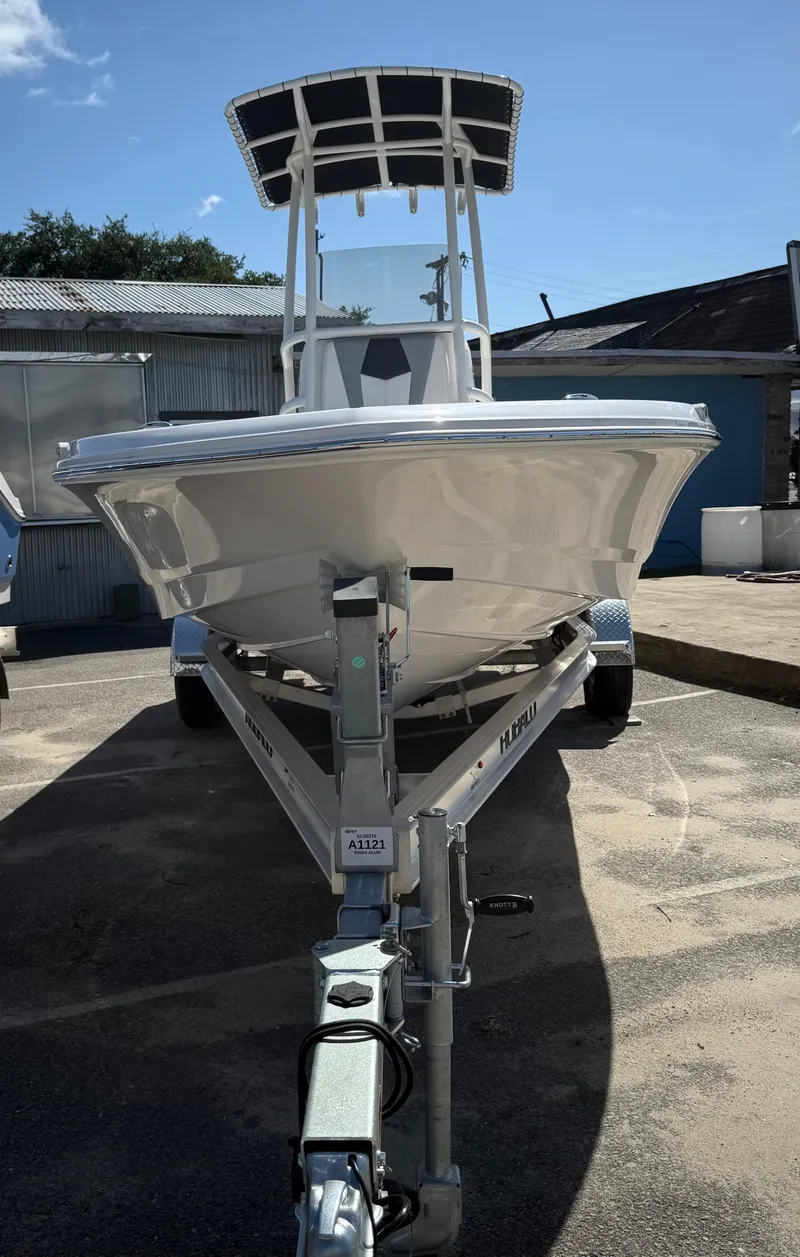 Slide: The Image of 2025 Robalo 206 Cayman boat on trailer, parked outdoors under clear blue sky. - 4