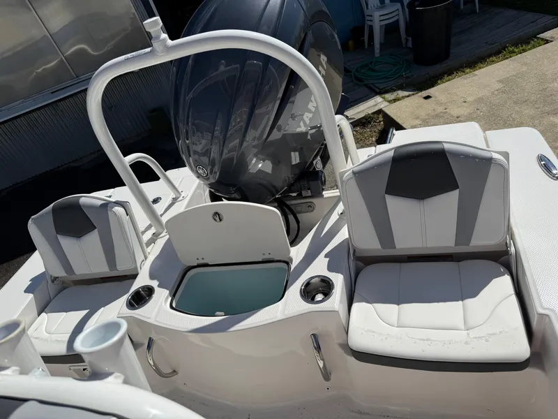 Slide: The Image of 2025 Robalo 206 Cayman boat interior with seating and Yamaha engine. - 5