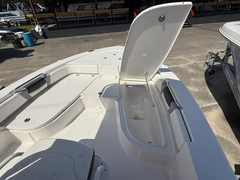 Slide: The Image of 2025 Robalo 206 Cayman boat with open storage compartment on deck. - 6