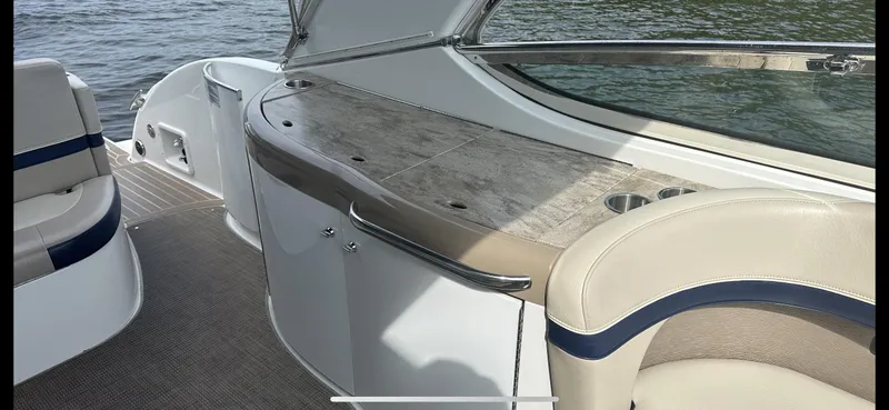 Slide: The Image of 2018 Formula 370 Super Sport boat interior with seating and countertop, near water. - 10