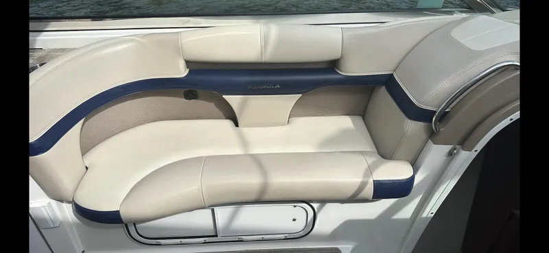 Slide: The Image of Luxury seating on a 2018 Formula 370 Super Sport boat, featuring beige and navy upholstery. - 11