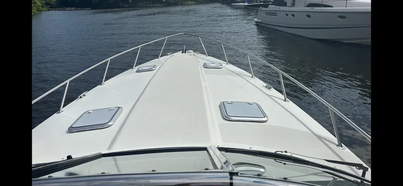 Slide: The Image of 2018 Formula 370 Super Sport boat on calm water, viewed from the bow. - 13