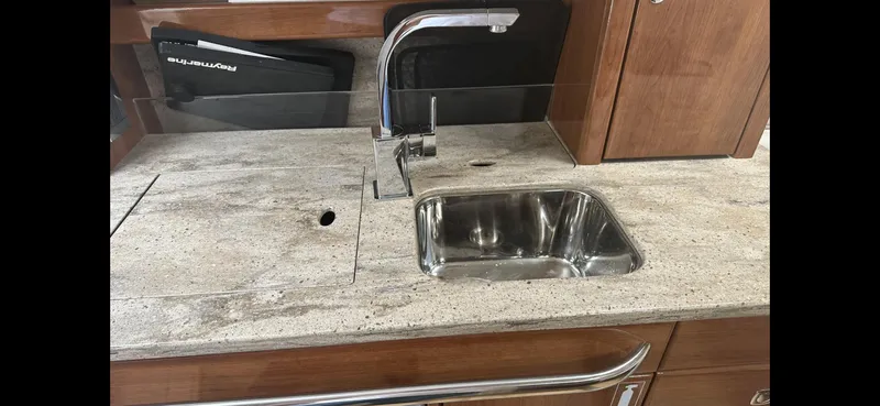Slide: The Image of 2018 Formula 370 Super Sport yacht kitchen sink with sleek countertop and modern faucet. - 18