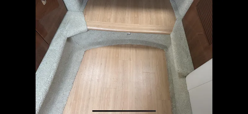 Slide: The Image of Interior view of 2018 Formula 370 Super Sport with wooden flooring and carpeted steps. - 19