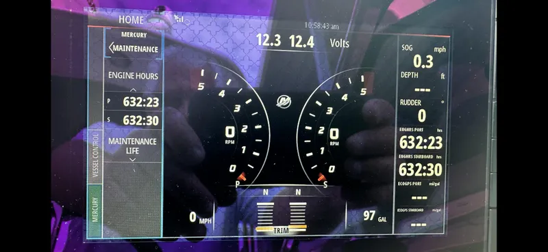 Slide: The Image of Dashboard of a 2018 Formula 370 Super Sport boat showing engine hours and gauges. - 2