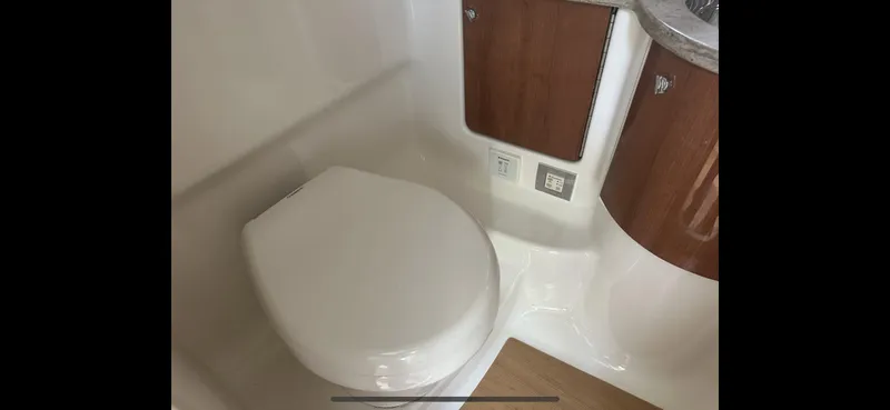 Slide: The Image of 2018 Formula 370 Super Sport bathroom with modern fixtures and wooden cabinetry. - 21