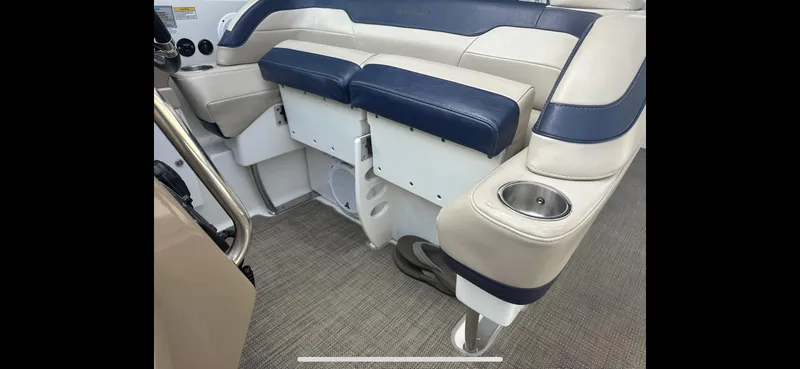 Slide: The Image of 2018 Formula 370 Super Sport boat interior with blue and beige seating and cup holder. - 23