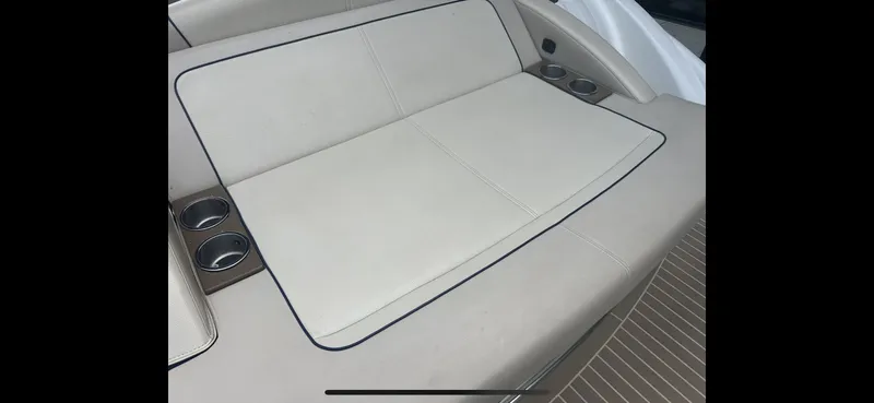 Slide: The Image of 2018 Formula 370 Super Sport boat seating with cup holders, beige upholstery. - 25
