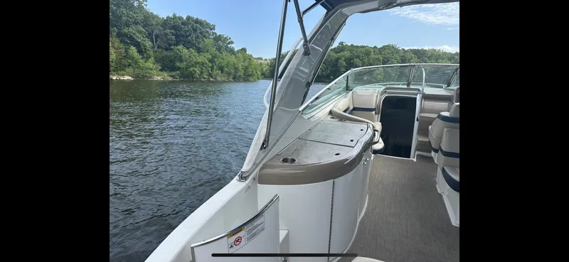Slide: The Image of 2018 Formula 370 Super Sport boat interior with lake view and lush greenery. - 27