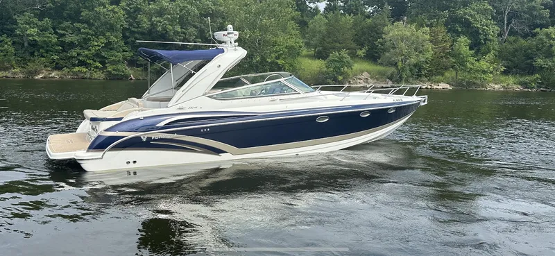 Slide: The Image of 2018 Formula 370 Super Sport boat cruising on a calm river with lush green trees. - 30