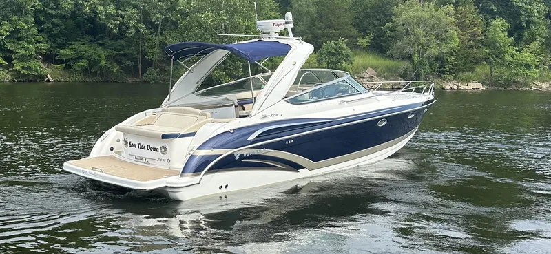 Slide: The Image of 2018 Formula 370 Super Sport boat cruising on a calm lake with lush green surroundings. - 31