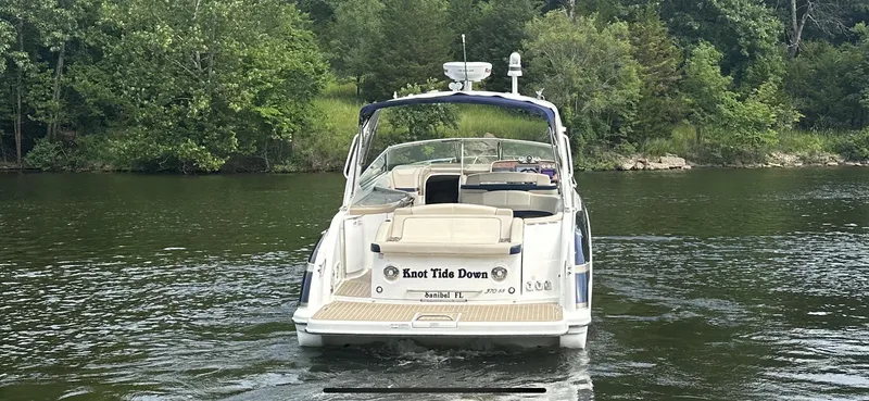 Slide: The Image of 2018 Formula 370 Super Sport boat cruising on a serene lake with lush green trees. - 32