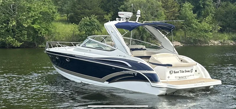 Slide: The Image of 2018 Formula 370 Super Sport boat cruising on a serene lake with lush greenery. - 33